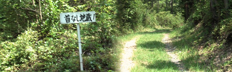 首なし地蔵跡の案内板と街道。