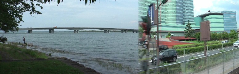 琵琶湖に架かる近江大橋有料道路と浜大津付近の街並み。